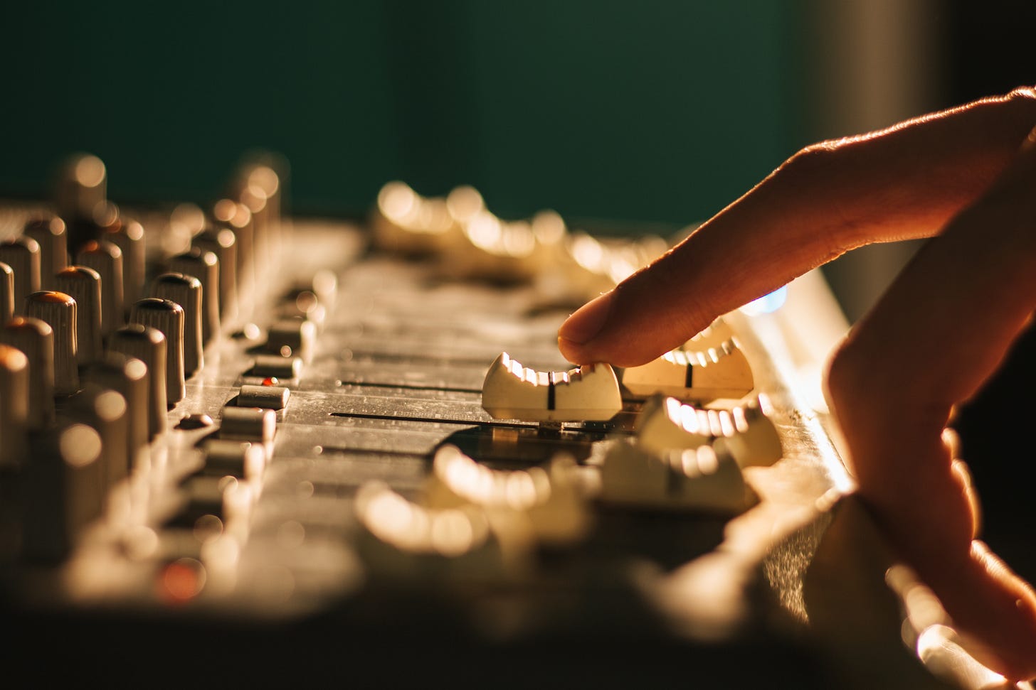 Fingers on soundboard faders