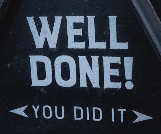 a sign that says well done you did it a sign that says well done you did it