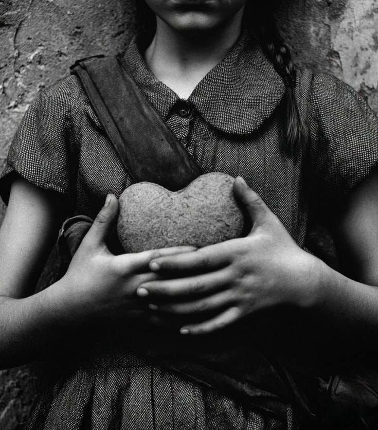 May be a black-and-white image of child and heart