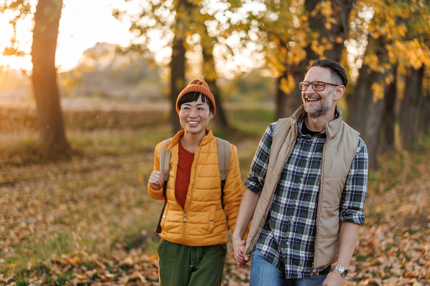 Smiling couple walking in nature holding hands. Smiling couple walking in nature holding hands.