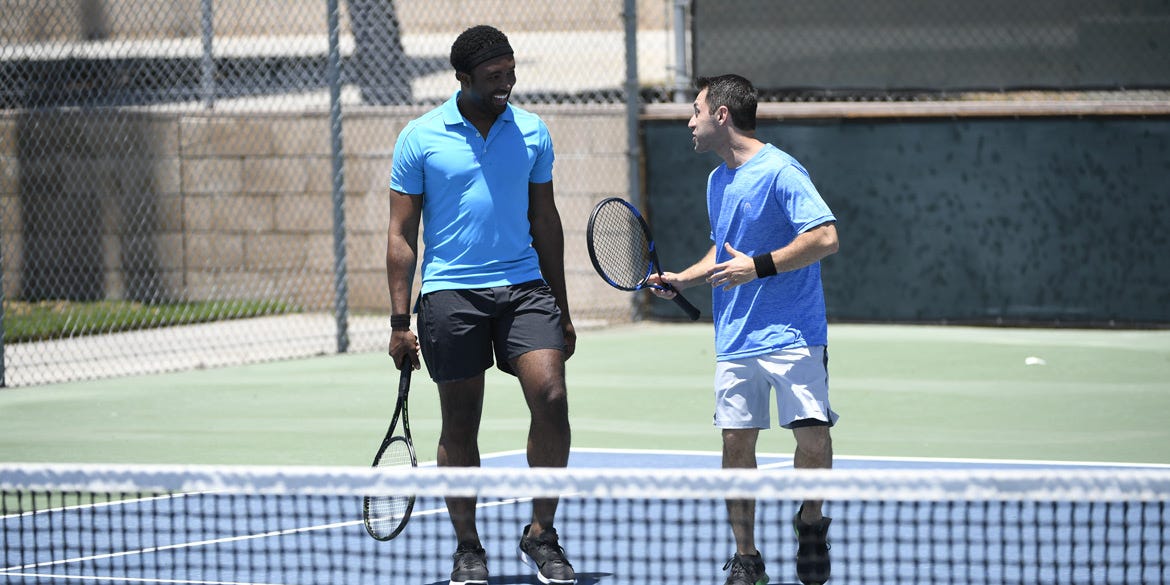 adult tennis players playing in tournament adult tennis players playing in tournament