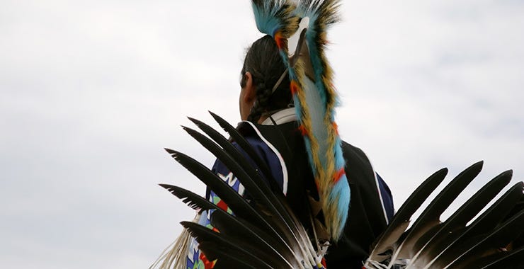 person dressed in traditional Native American clothing