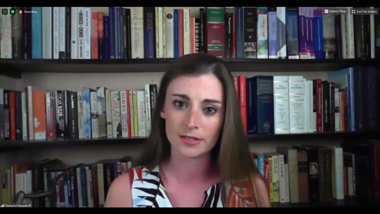 A person in front of a bookshelf

AI-generated content may be incorrect.
