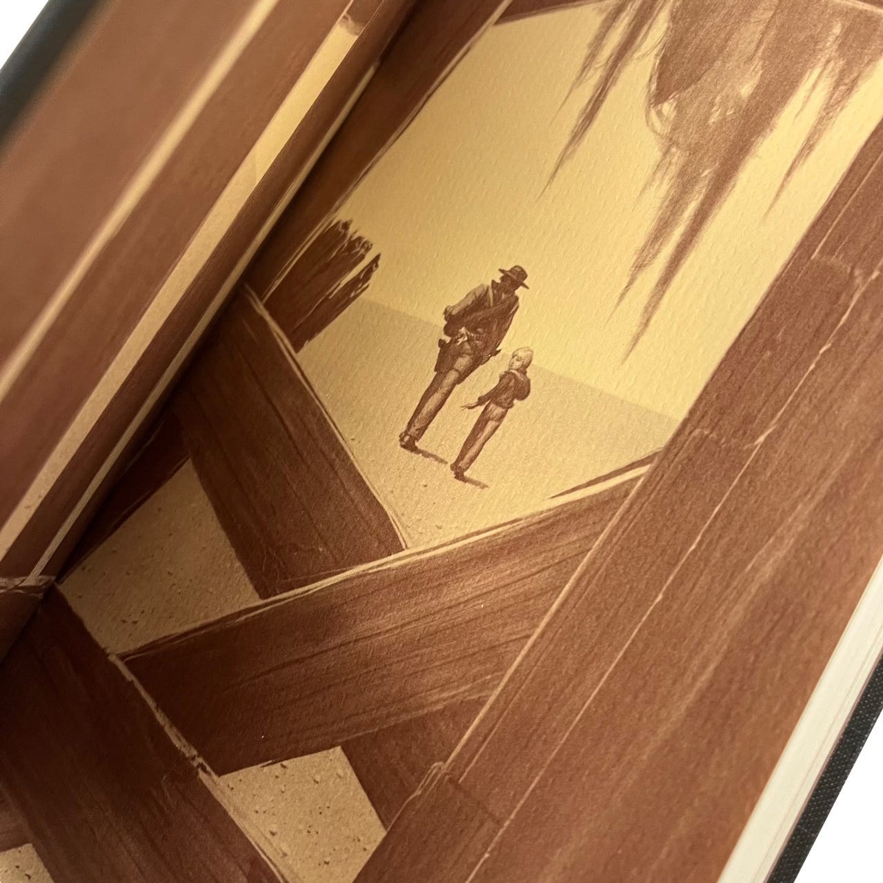 The Gunslinger (2nd edition) with page open to the front endpapers, illustrating the painting in its original form without the ropes.