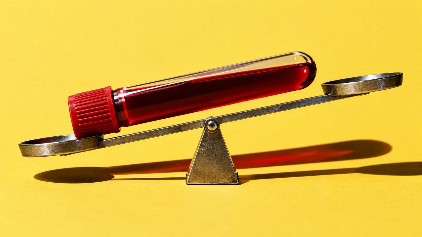 Blood sample tube balanced on a scale Blood sample tube balanced on a scale