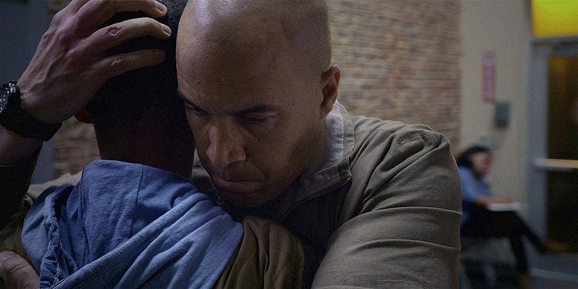 Walker James holding son DJ head with hand and hugging tight. Walker James holding son DJ head with hand and hugging tight.