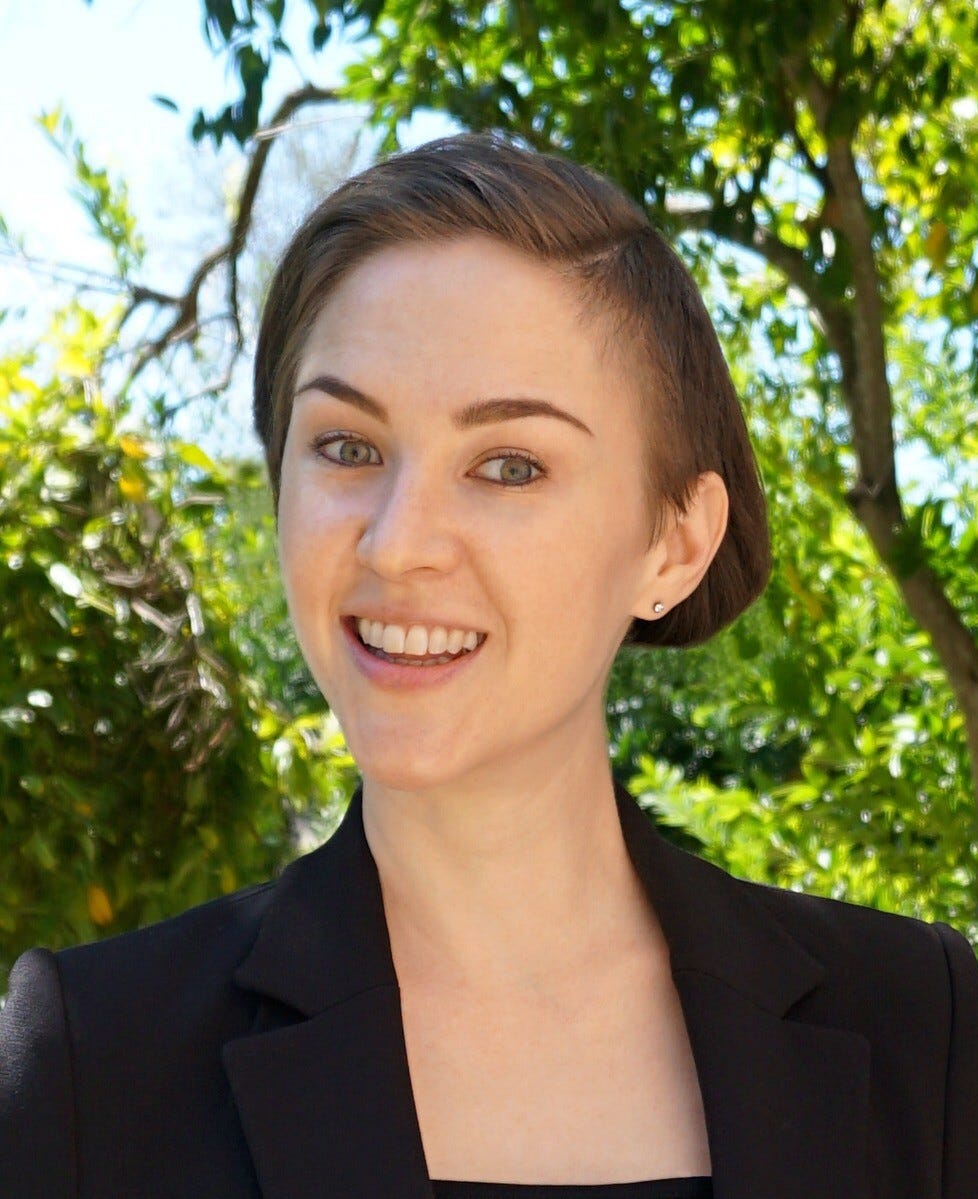 A person smiling at the camera

Description automatically generated