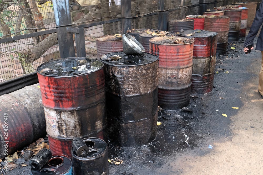 Old rusty barrel left in the road leaking thick black tar or oil on an  urban street in Kolkata, India Stock Photo | Adobe Stock
