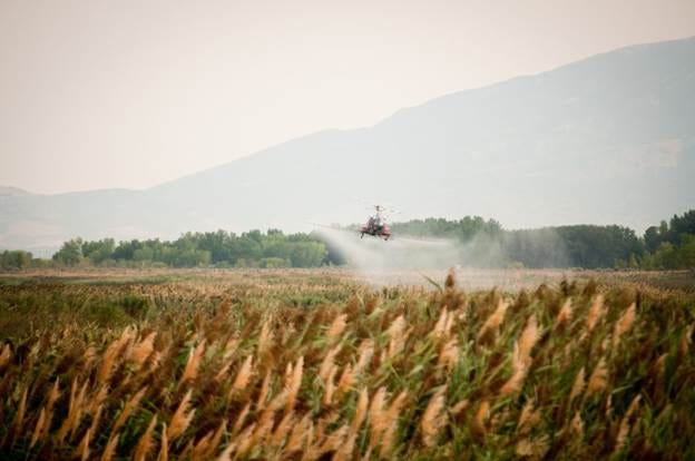 A tractor spraying a field

Description automatically generated