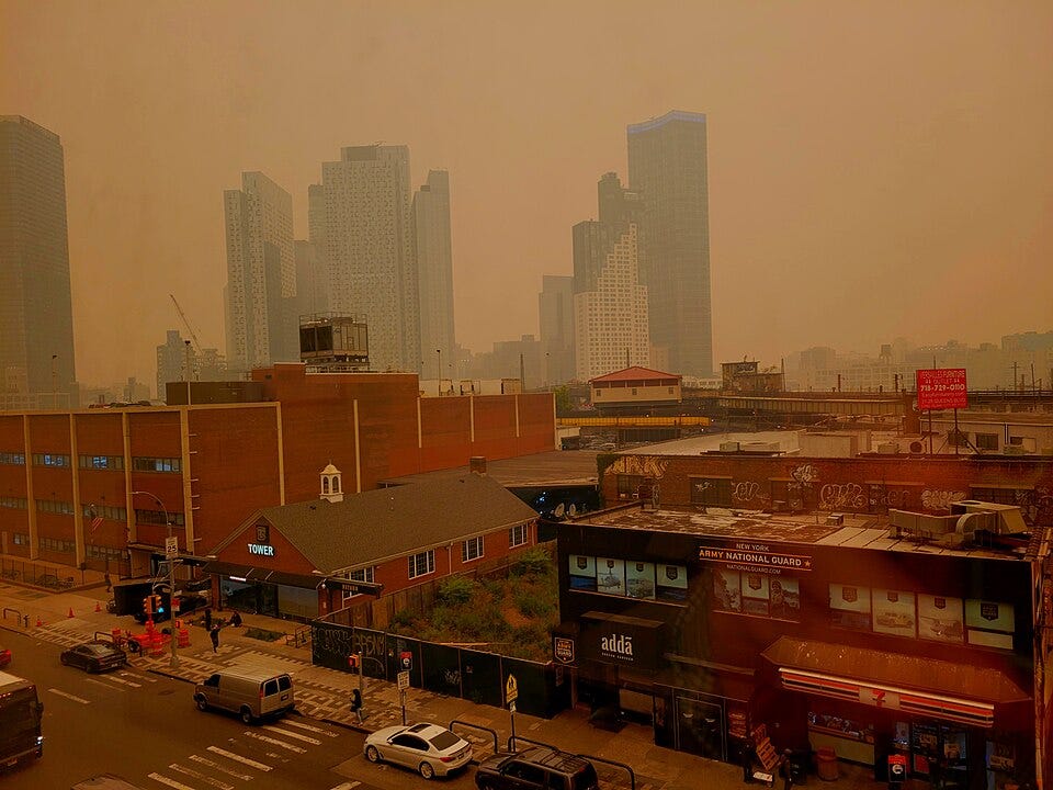 Long Island City high-rises fade into dense orange smoke above low-rise buildings in Queens. Long Island City high-rises fade into dense orange smoke above low-rise buildings in Queens.