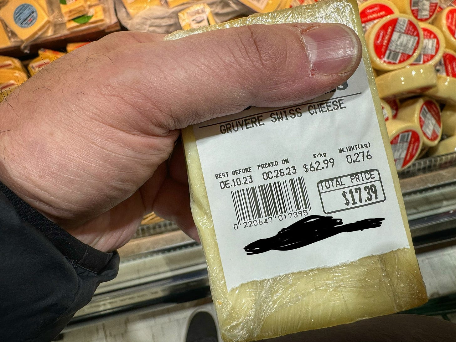 A piece of Gryuere cheese at a supermarket. 0.276 kg costs $17.39. The price per kilogram is $62.99 A piece of Gryuere cheese at a supermarket. 0.276 kg costs $17.39. The price per kilogram is $62.99