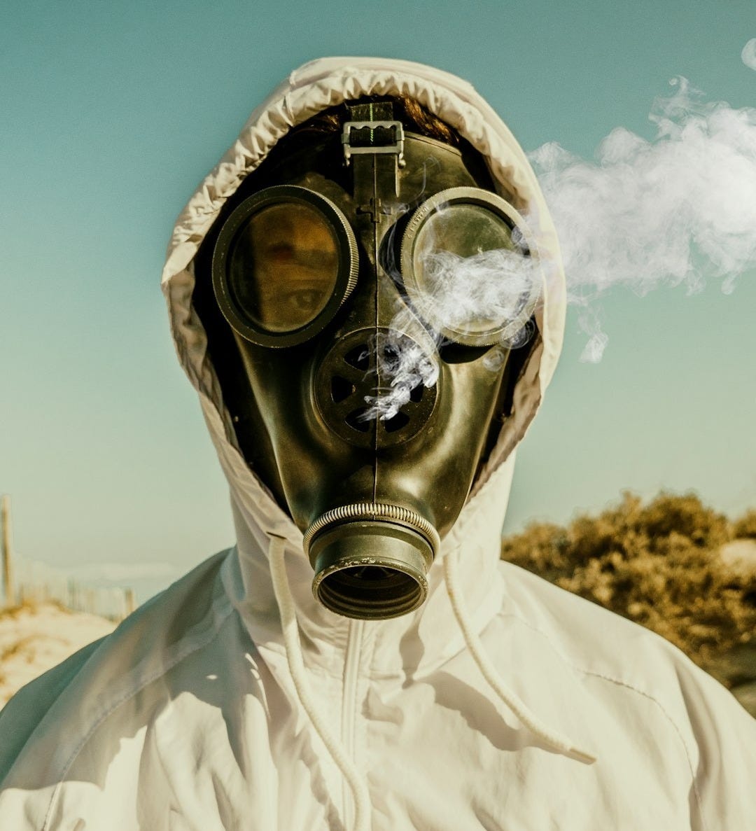 person wearing white and blue gas mask