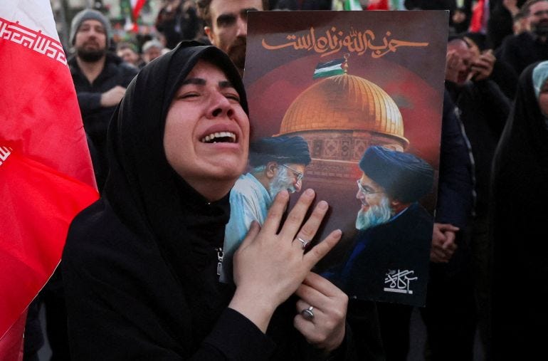 A woman reacts as people gather at the Enghelab Square, after Iran's Supreme Leader Ayatollah Ali Khamenei was killed in Israeli and U.S. strikes on Saturday, in Tehran, Iran, March 1, 2026. Majid Asgaripour/WANA (West Asia News Agency) via REUTERS ATTENTION EDITORS - THIS PICTURE WAS PROVIDED BY A THIRD PARTY TPX IMAGES OF THE DAY A woman reacts as people gather at the Enghelab Square, after Iran's Supreme Leader Ayatollah Ali Khamenei was killed in Israeli and U.S. strikes on Saturday, in Tehran, Iran, March 1, 2026. Majid Asgaripour/WANA (West Asia News Agency) via REUTERS ATTENTION EDITORS - THIS PICTURE WAS PROVIDED BY A THIRD PARTY TPX IMAGES OF THE DAY