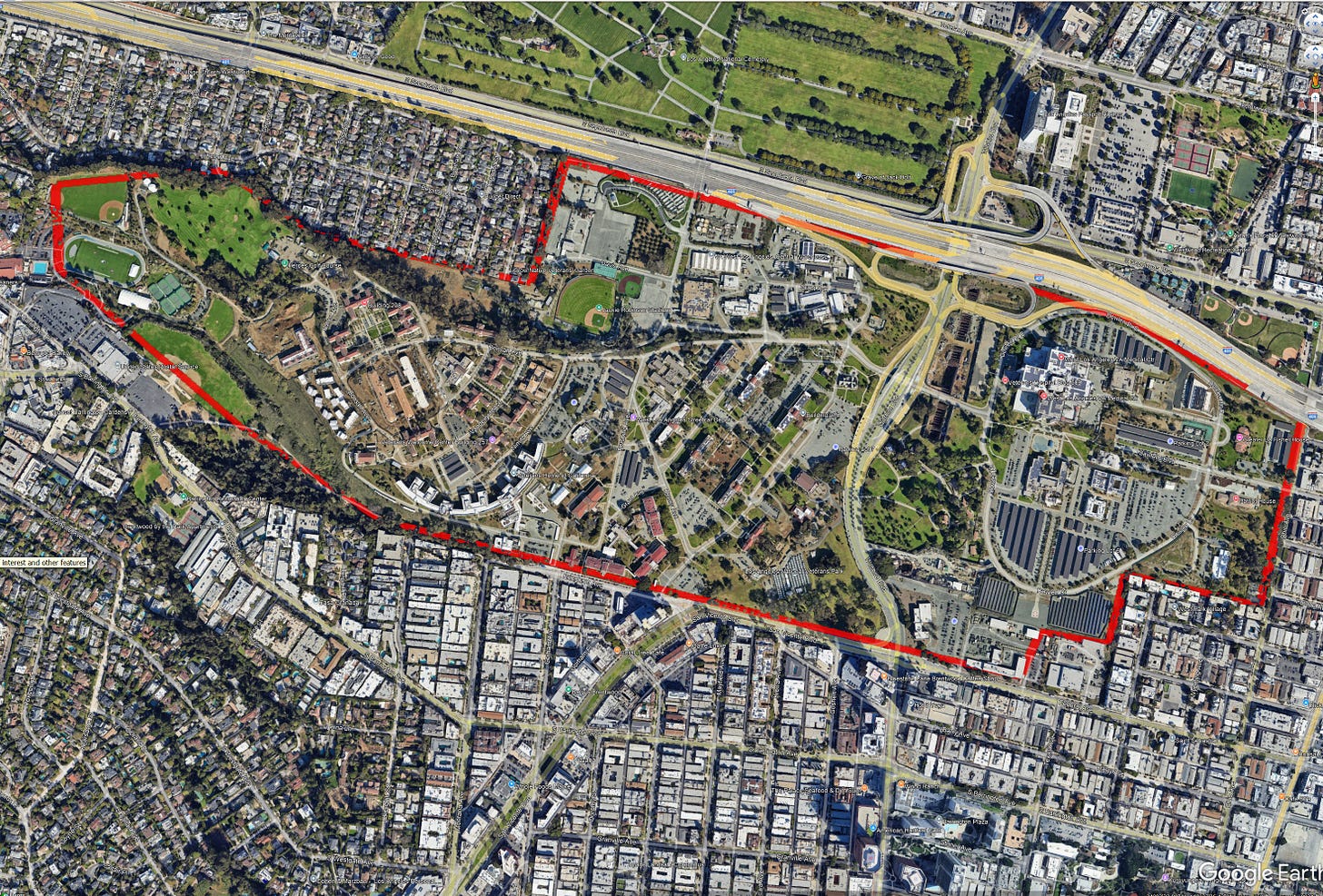 Satellite view of a large VA campus with medical facilities, housing, and sports fields