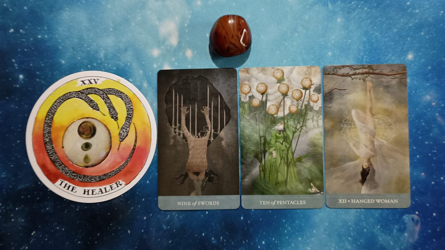 New Moon Pick-a-Card Tarot Reading for June 2025, pile 2 - Silk Agate stone (orange and brown) and 4 cards on a starry blue background