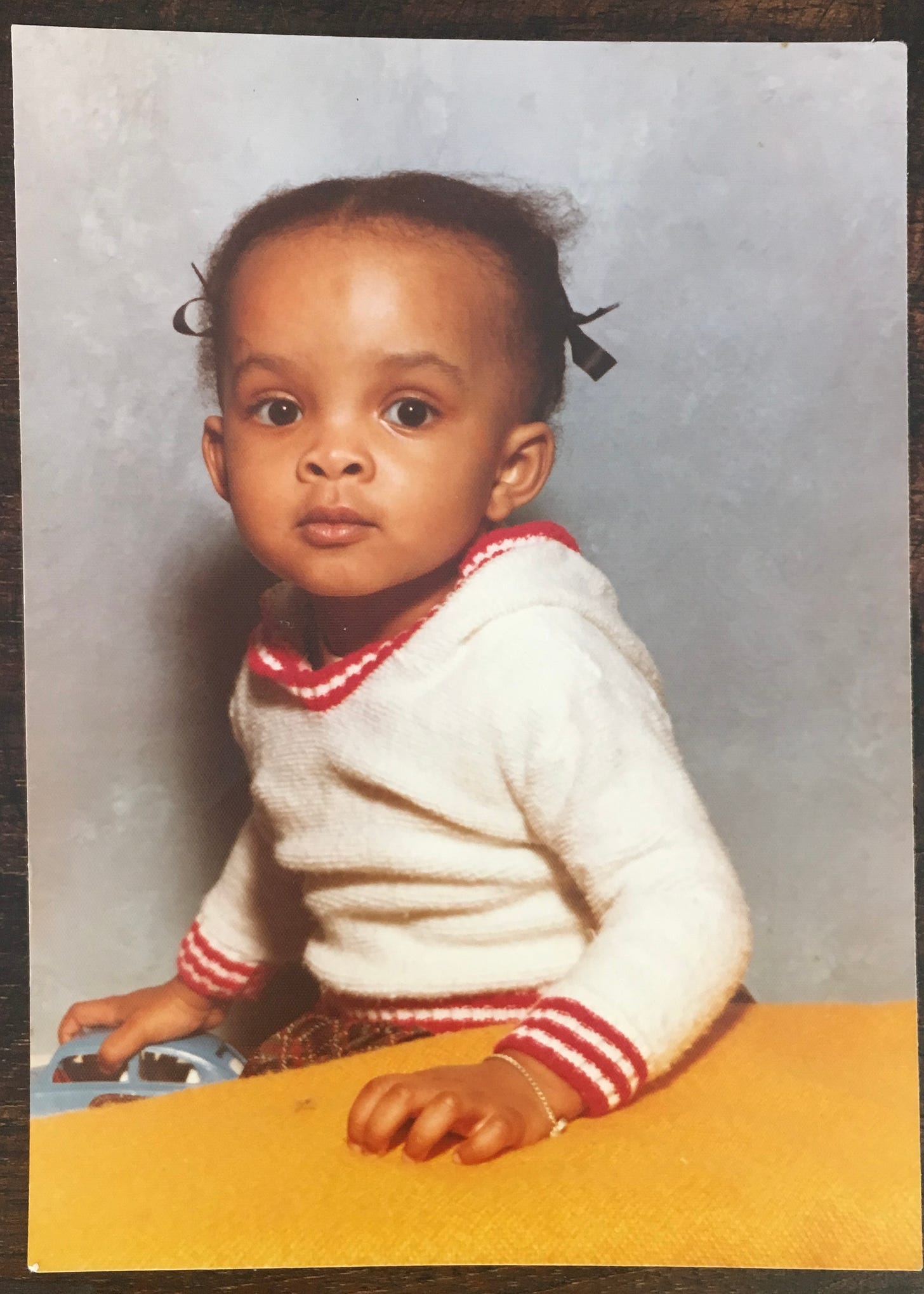 Baby Nataliie Lue in a red and white hoodie