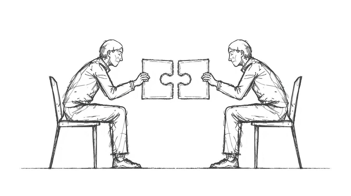 Two equal figures each holding a complementary puzzle fragment that meets between them