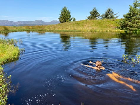 Nine photos of retreats. A white house nestling int he mountains. Chocolate cake covered in borage flowers. A window seat with books. A wooden wall in a cosy bedroom. A woman raising her arms in joy at the big sky. A person swimming in a blue lake. Four women smiling with a hill behind them. A roll top bath with candles. A computer surrounded by post it notes with a mountain view.