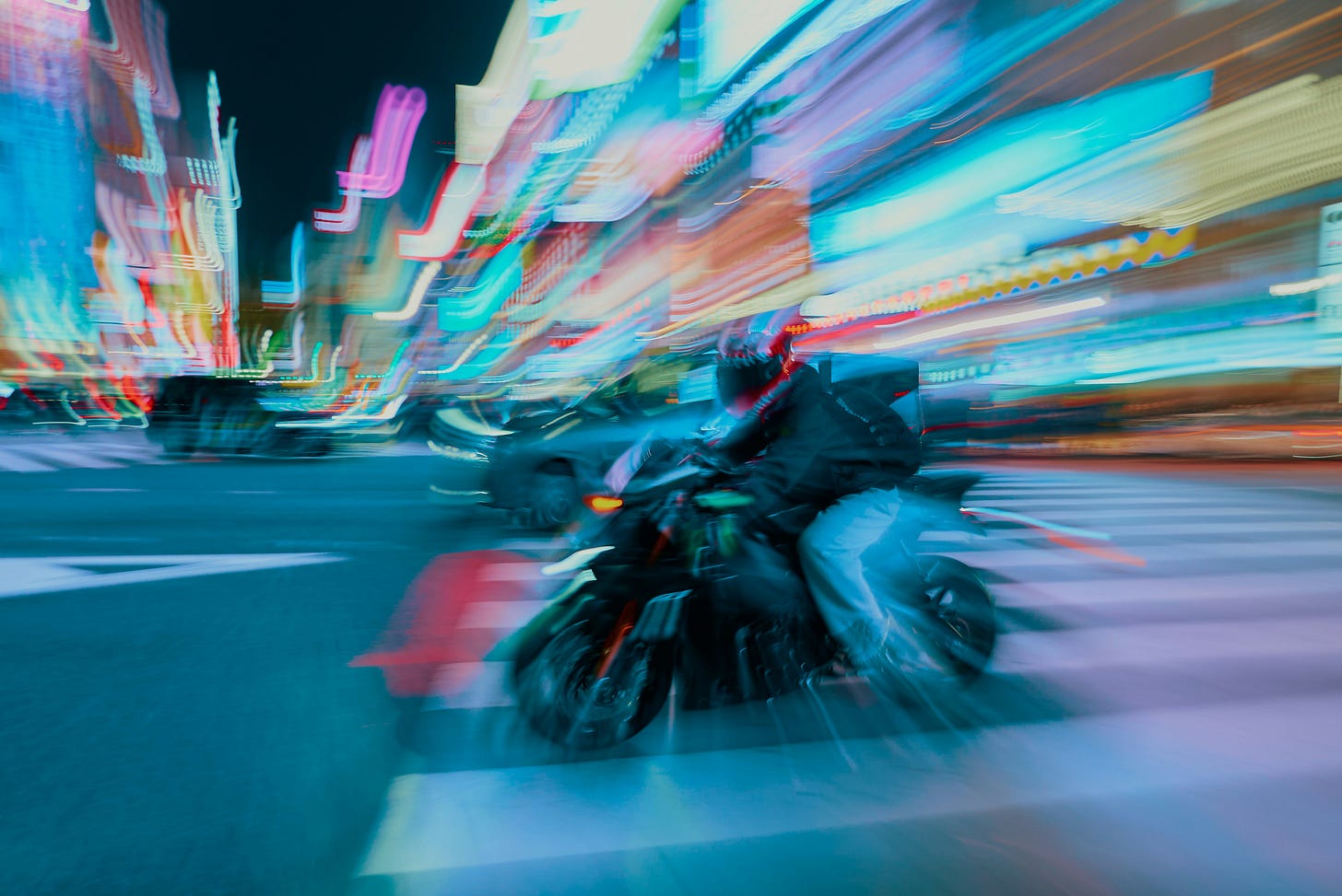 Motorcycle speeding through Tokyo streets at night indicating speed and agility for domestic business.