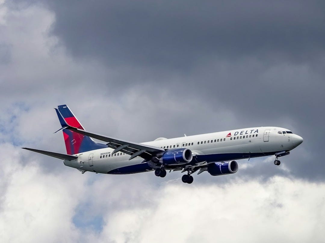 Delta airplane flying through clouds