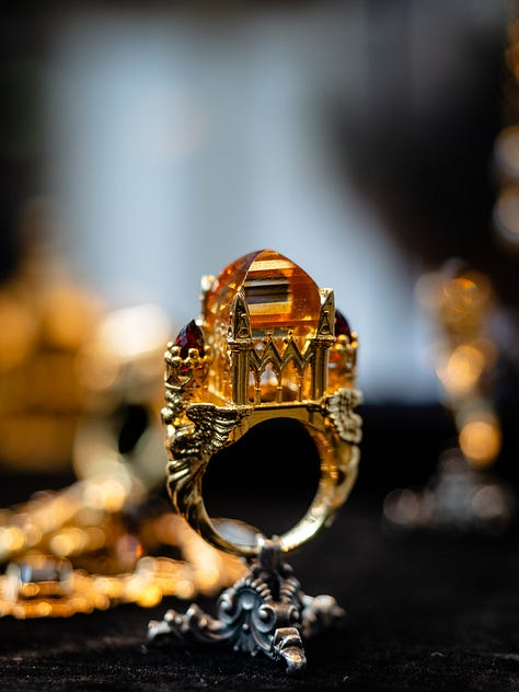 An antique opal and diamond watch in the Flames of Opal Essence exhibition, a ring by Sharvash Hakobian, a dragonfly brooch by Chong Ho, a brooch at Strong & Precious, a necklace by Jaqueline Powers, a ring by William Llewellyn Griffiths, all on show at GemGenève.