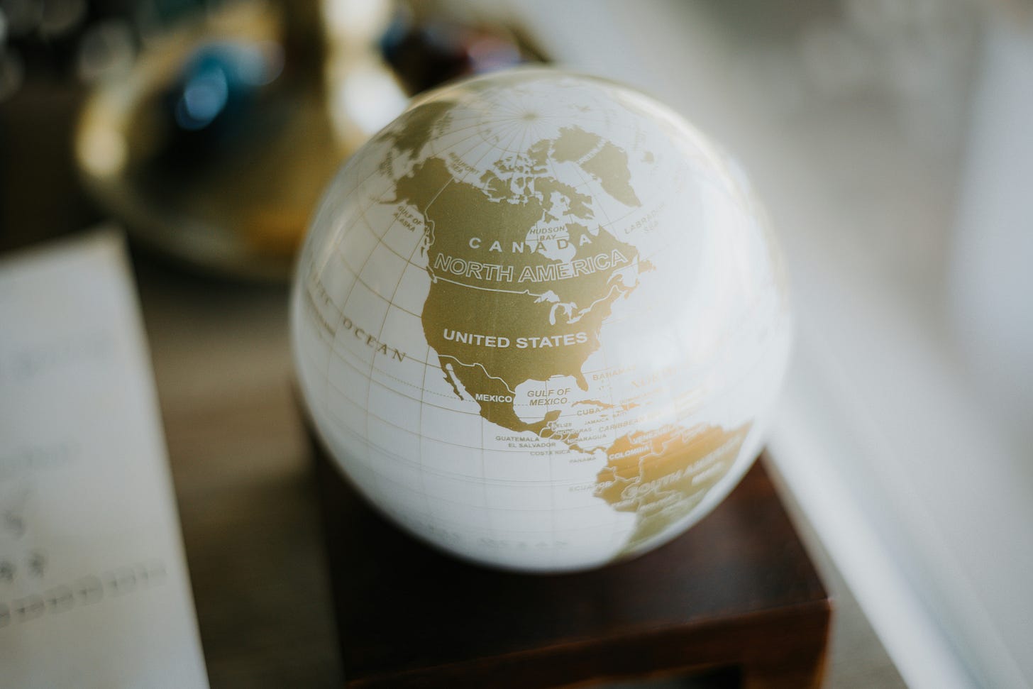 A decorative globe sitting on a desk. 