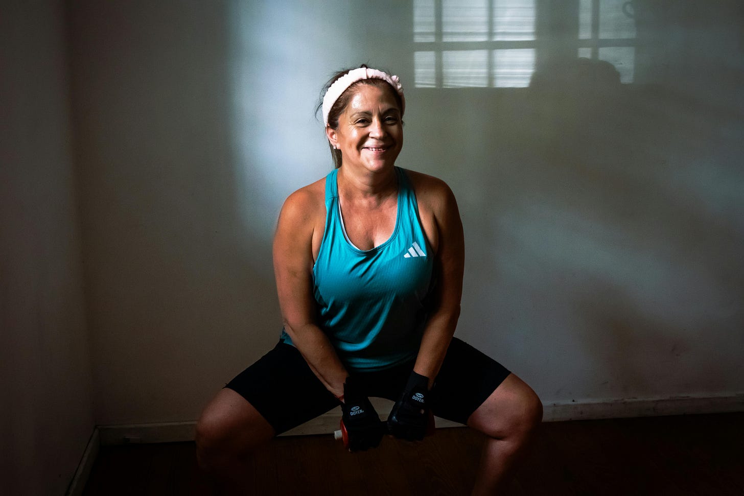 Image of an older woman training with a dumbbell