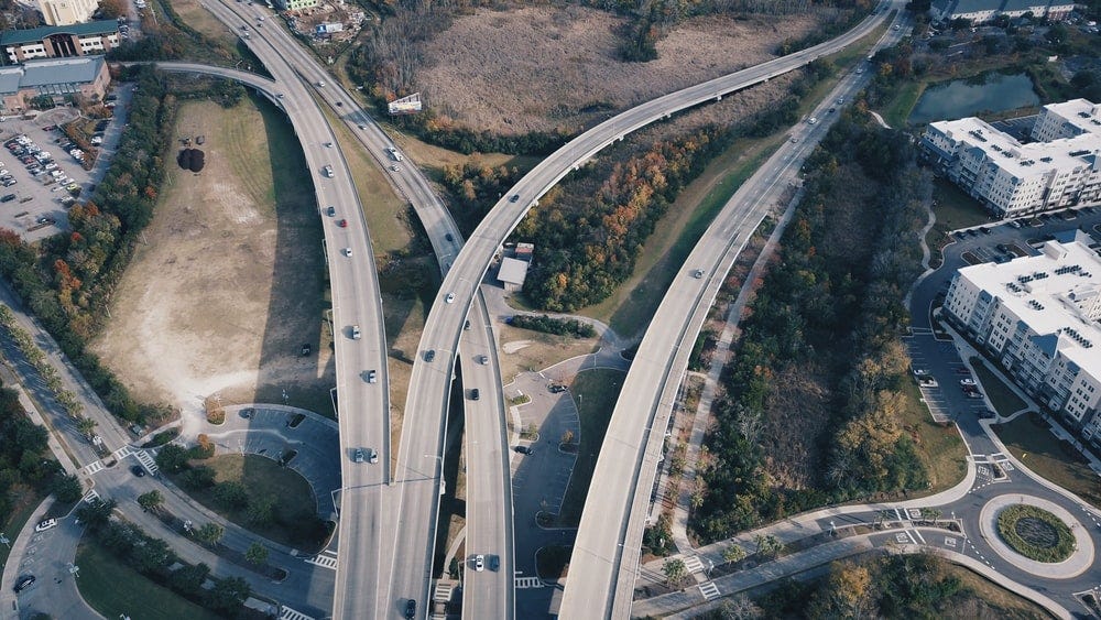 aerial photography of cars on concrete road during daytime aerial photography of cars on concrete road during daytime