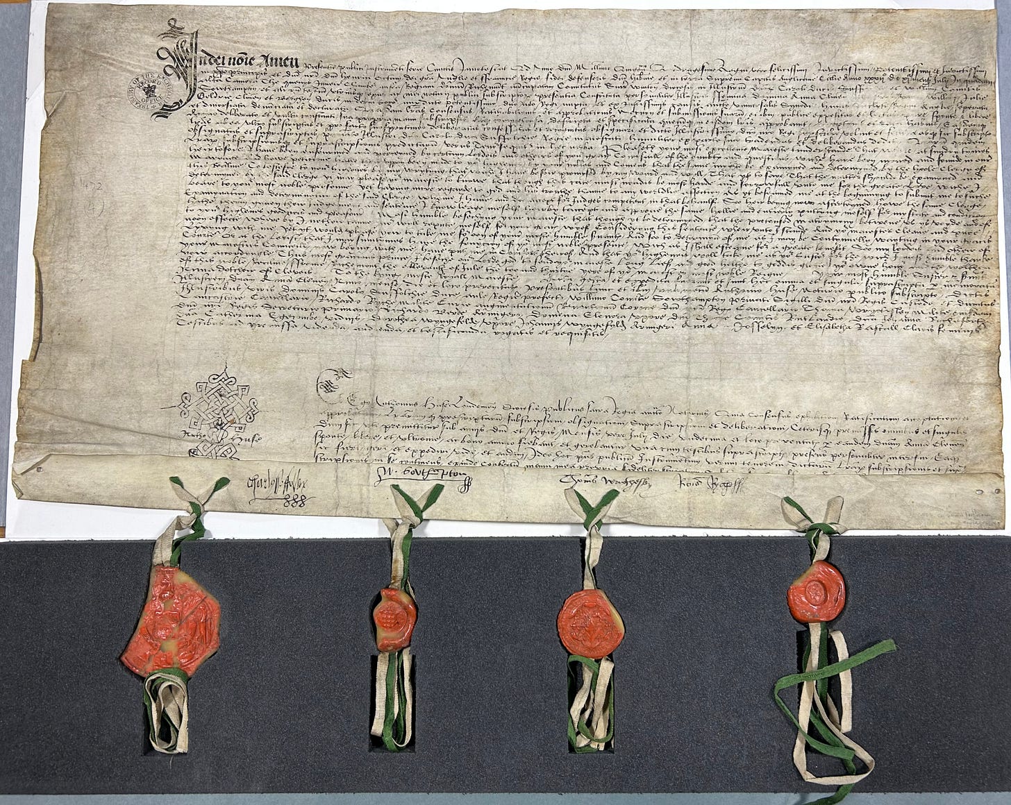 A sixteenth century legal document, spread out, with four seals of nobles attached at the bottom