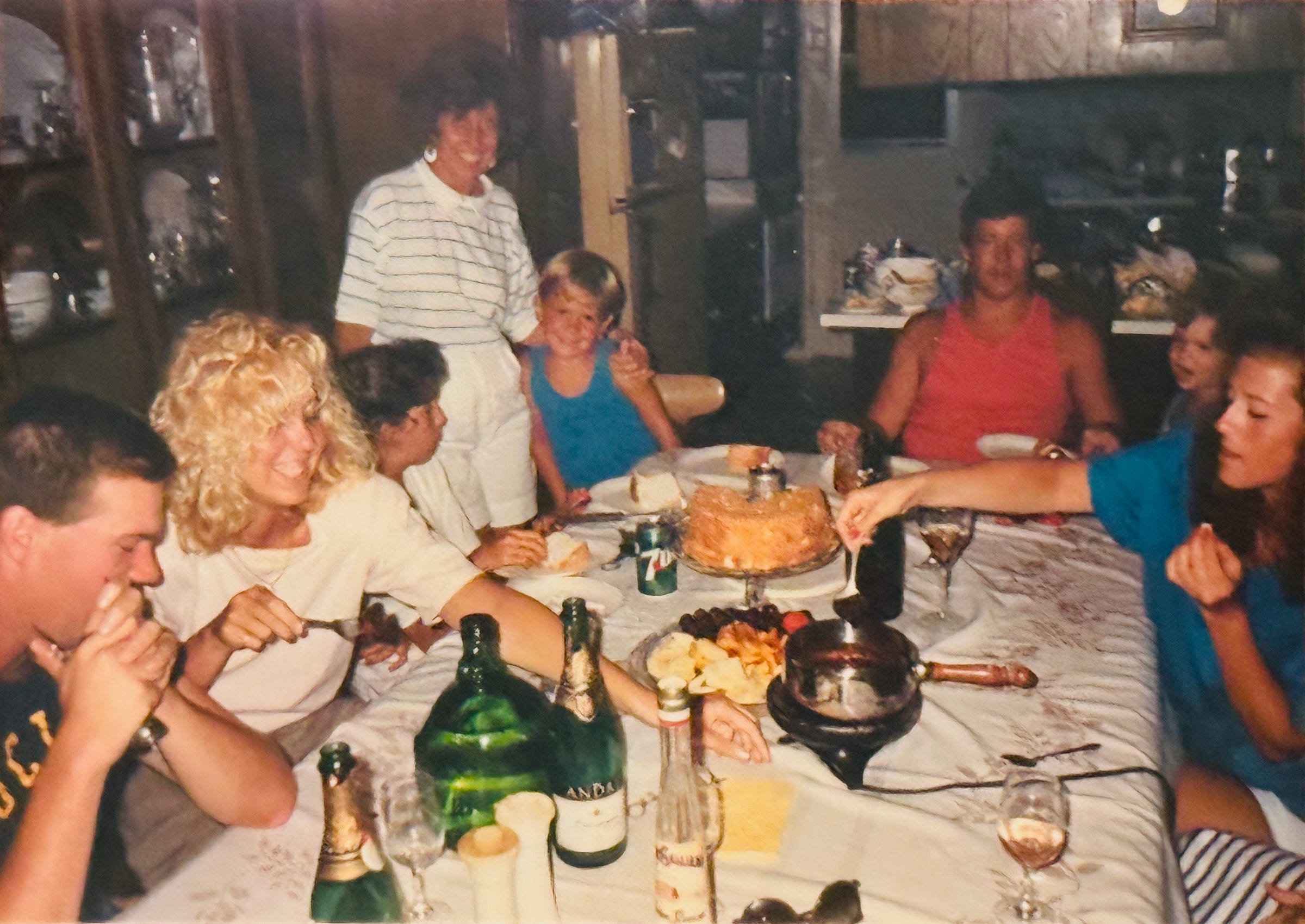 Family gathered around the dining table in Huntington Beach — twenty-one years of gatherings behind The Ritual at The Dinner Bell