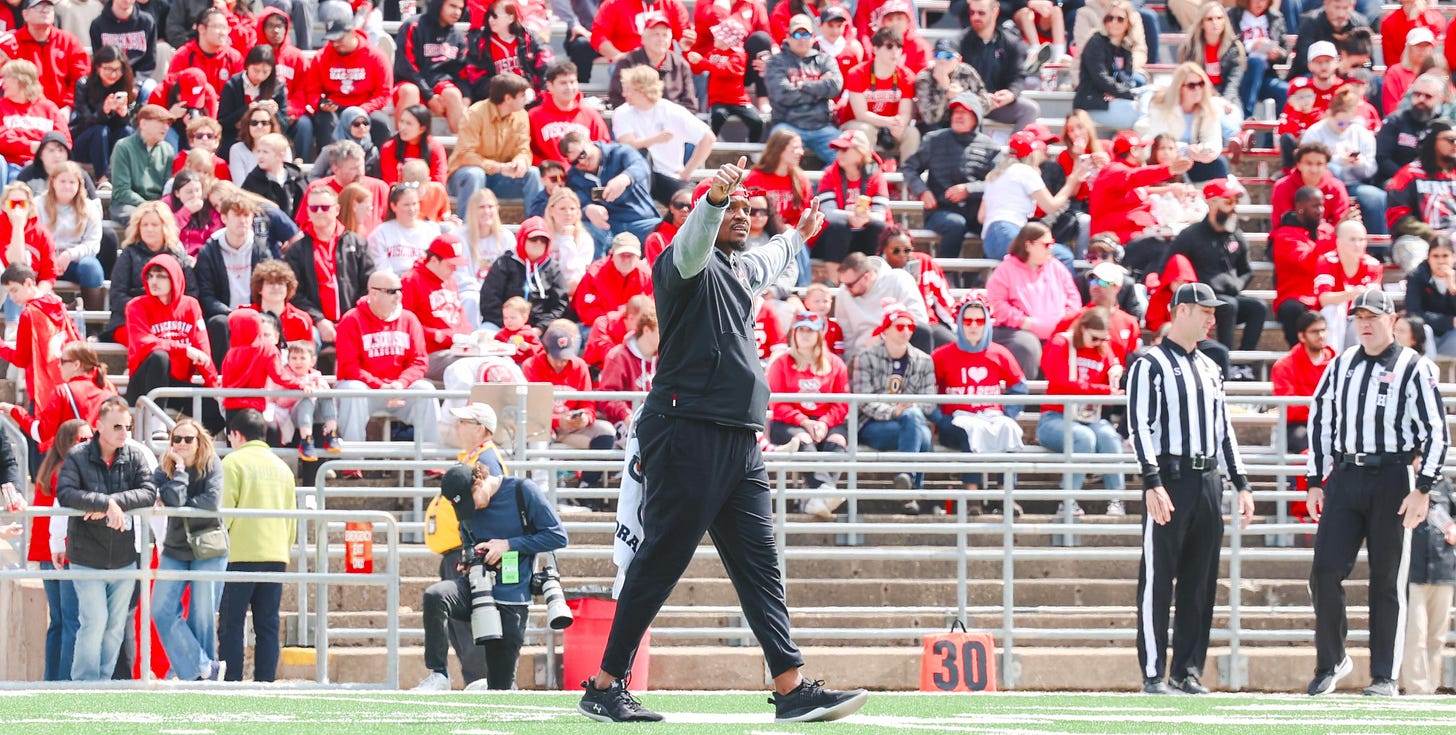 Wisconsin Badgers wide receivers coach Jordan Reid steps onto the football field at Camp Randall Stadium