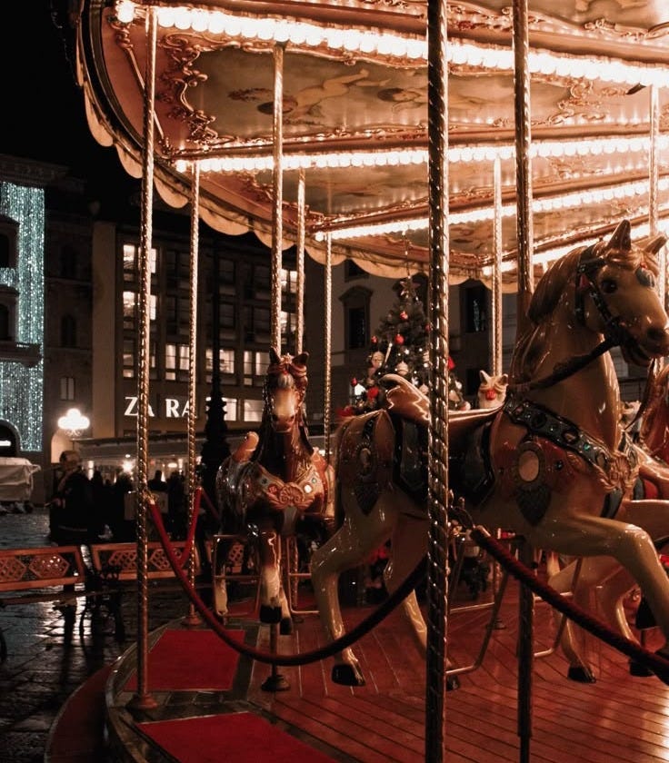 This may contain: an old fashioned merry go round at night