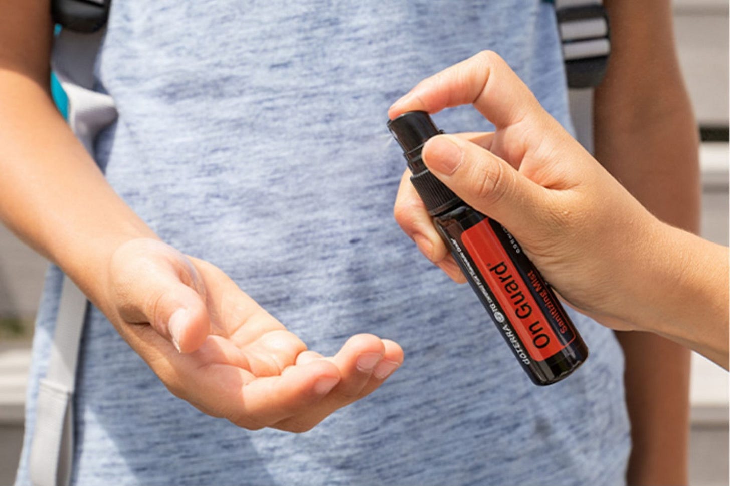 Onguard hand purifying mist by Doterra being sprayed into a hand.