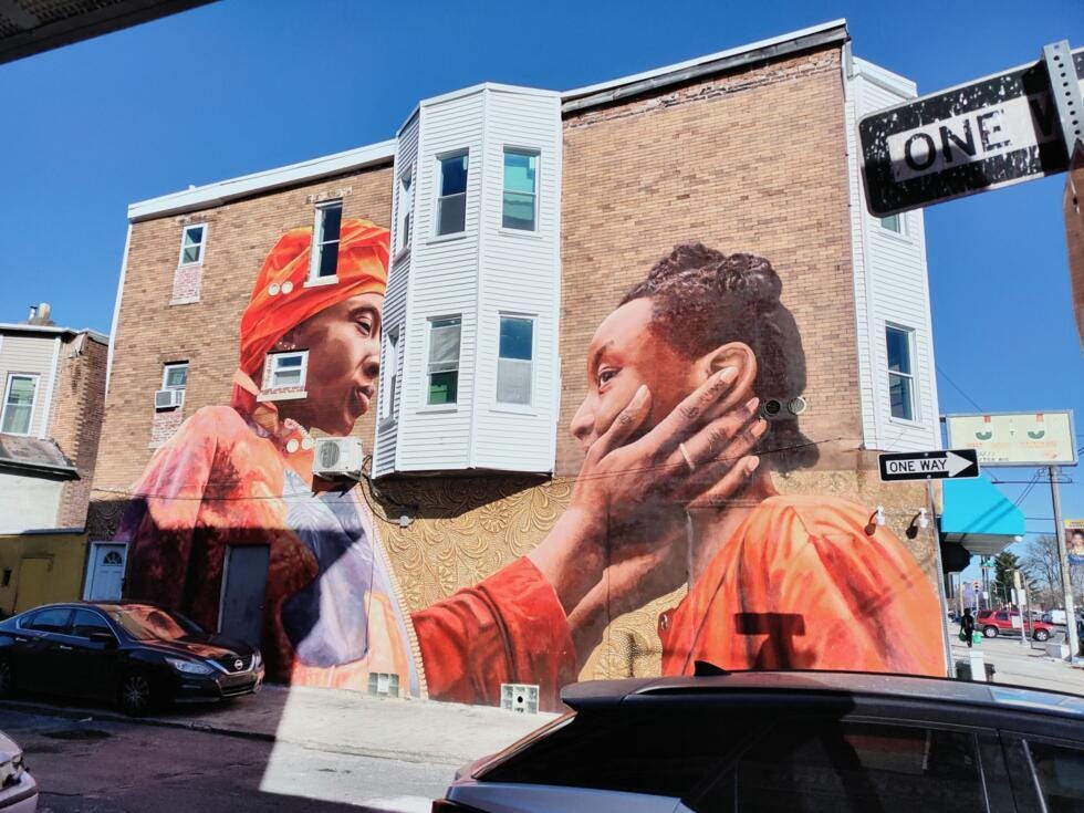 A mural by artist Walé Oyéjidé in Africatown symbolising harmony between the African American and African population of the community. A mural by artist Walé Oyéjidé in Africatown symbolising harmony between the African American and African population of the community.