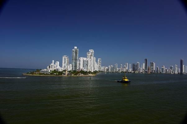 A boat in the water with a city in the background

AI-generated content may be incorrect.