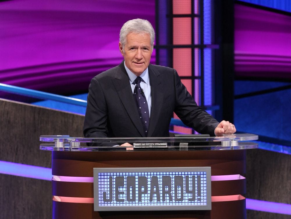 Alex Trebek (July 22, 1940 – November 8, 2020) at his lectern on the set of Jeopardy!, which Trebek hosted for more than thirty-six seasons