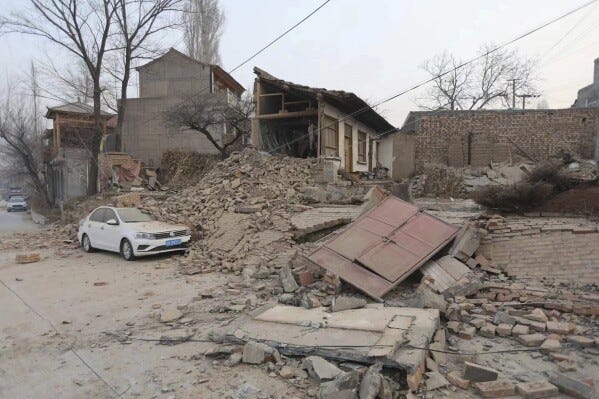 A vehicle is partially covered by a collapsed building in the aftermath of an earthquake in Dahejia village of Jishishan county in northwestern China's Gansu province Tuesday, Dec. 19, 2023. An overnight earthquake killed multiple people in a cold and mountainous region in northwestern China, the country's state media reported Tuesday.(Chinatopix via AP) A vehicle is partially covered by a collapsed building in the aftermath of an earthquake in Dahejia village of Jishishan county in northwestern China's Gansu province Tuesday, Dec. 19, 2023. An overnight earthquake killed multiple people in a cold and mountainous region in northwestern China, the country's state media reported Tuesday.(Chinatopix via AP)