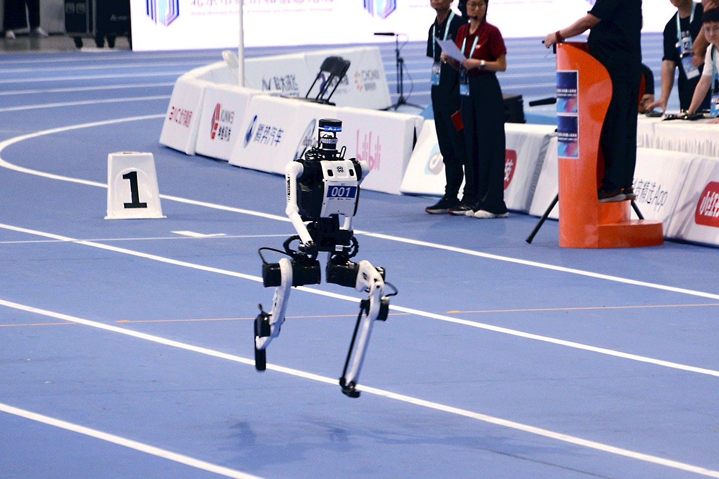 A humanoid robot running on a track. A humanoid robot running on a track.