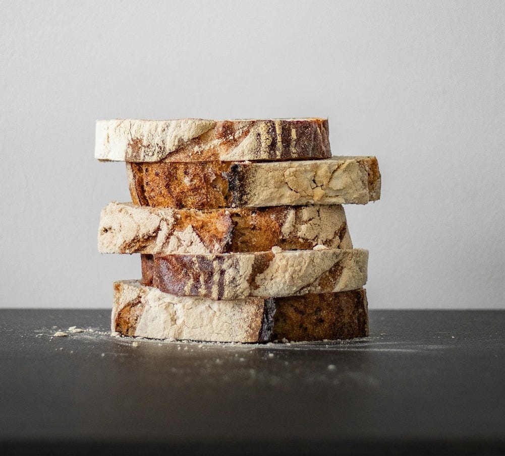 a stack of four pieces of bread sitting on top of a table