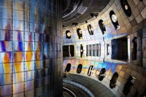 The inside of the DIII-D fusion vessel. The iridescent hues seen on some tiles lining the vessel come from atoms that can become lodged in the walls during plasma experiments.