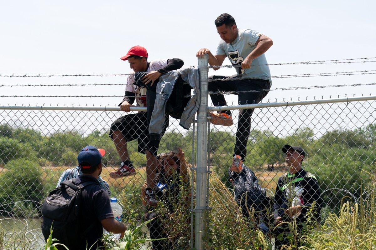 Illegal immigrants jump over the barbed wire fence into the United States from Mexico, in Eagle Pass, Texas, on Aug. 25, 2023. (Suzanne Cordeiro/AFP via Getty Images) Illegal immigrants jump over the barbed wire fence into the United States from Mexico, in Eagle Pass, Texas, on Aug. 25, 2023. (Suzanne Cordeiro/AFP via Getty Images)