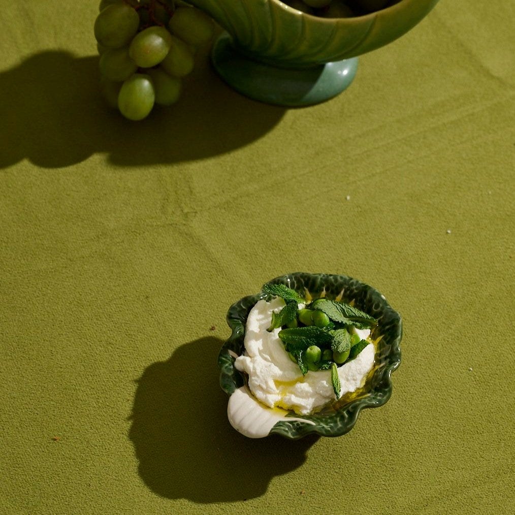 Whipped ricotta with fava beans and mint in a green cabbage-leaf bowl — fresh spring starter from the VERTE dinner party menu