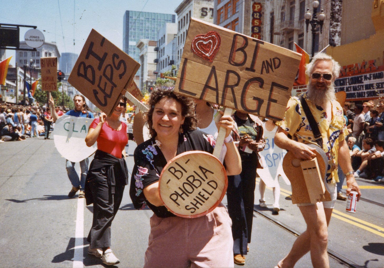 Arlene Krantz, BiPOL co-founder Lani Ka‘ahumanu wields her “Bi-Phobia Shield” as she marches with her contingent in the 1984 Lesbian and Gay Freedom Day Parade (1984). Left to right: BiPOL co-founder Bill Mack, Lynne Frawley, Ka‘ahumanu, unknown. Arlene Krantz, BiPOL co-founder Lani Ka‘ahumanu wields her “Bi-Phobia Shield” as she marches with her contingent in the 1984 Lesbian and Gay Freedom Day Parade (1984). Left to right: BiPOL co-founder Bill Mack, Lynne Frawley, Ka‘ahumanu, unknown.