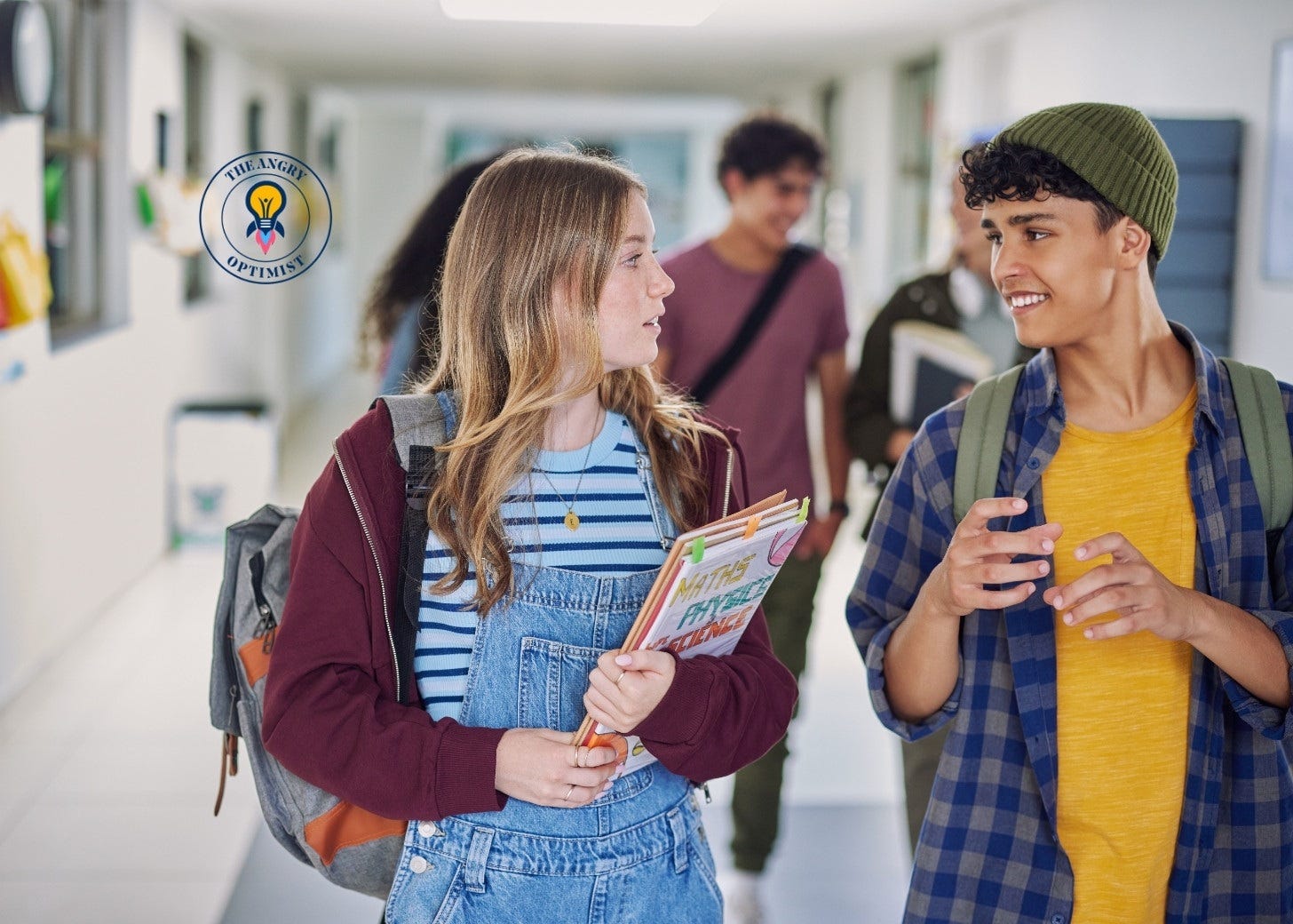 Teenagers with backpacks talking and laughing in a school corridor. Teenagers with backpacks talking and laughing in a school corridor.