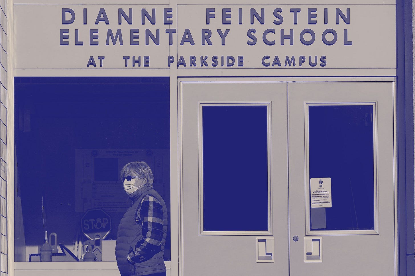 A person walking past Dianne Feinstein Elementary School