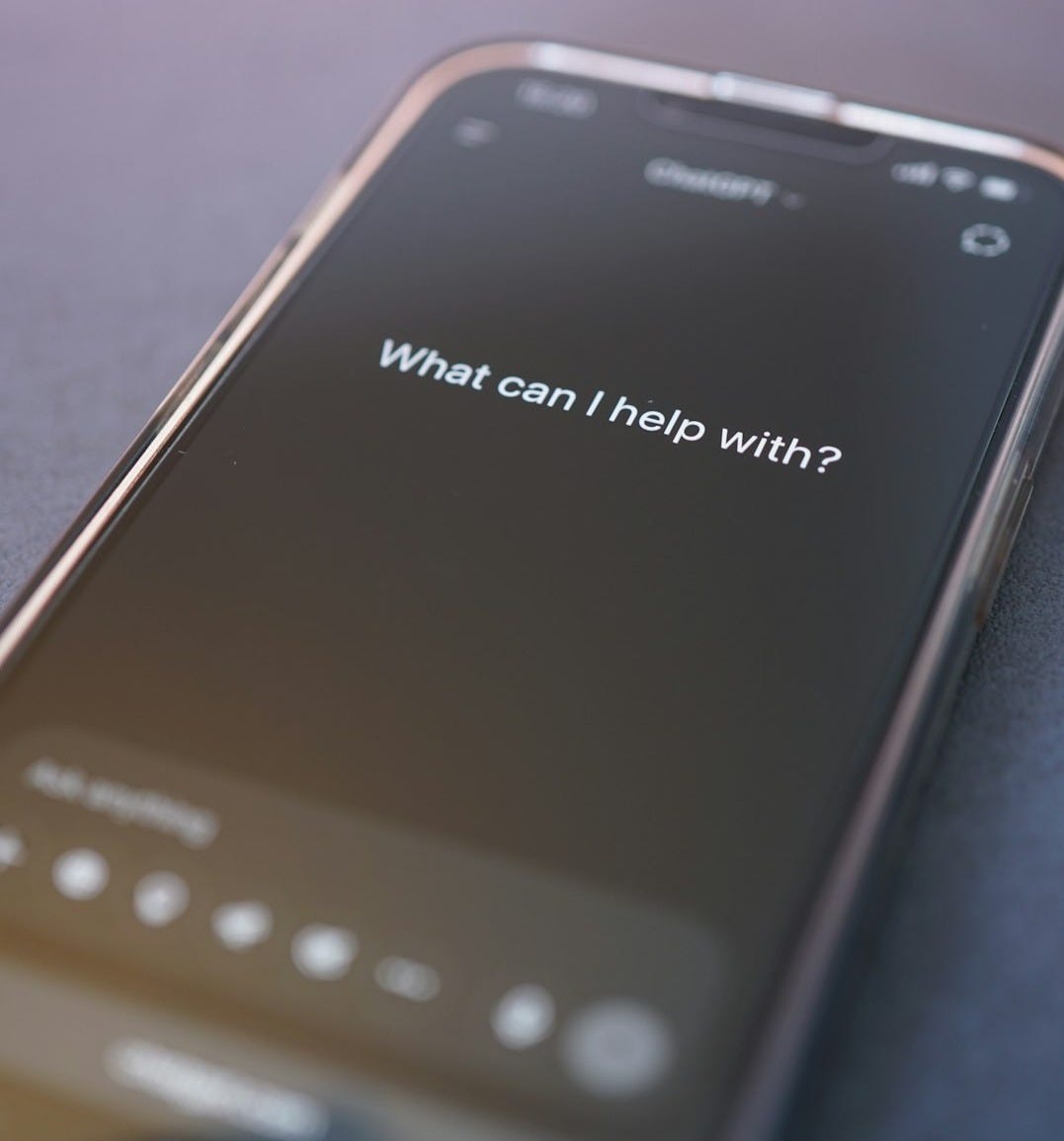 Phone screen asks: "what can i help with?"