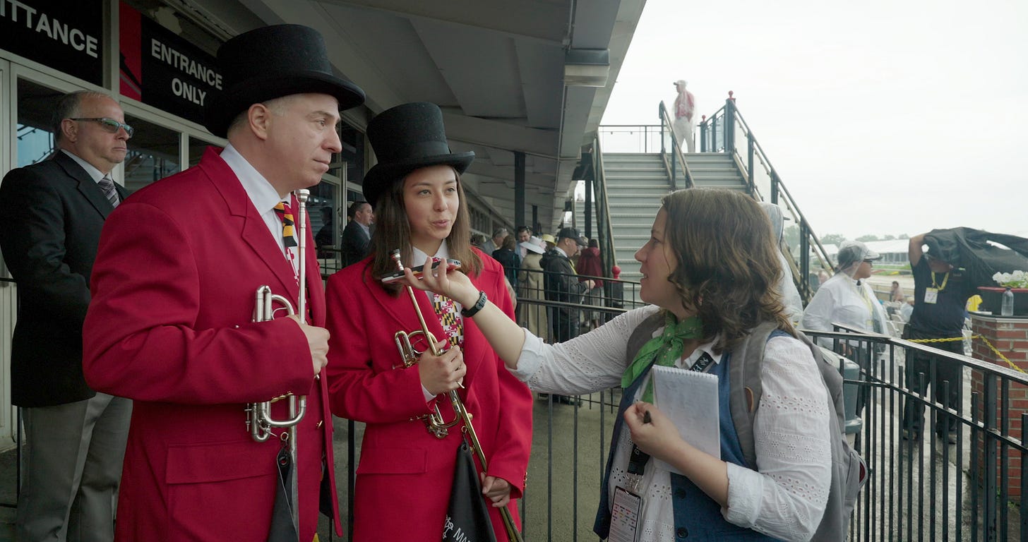 reporter talks to buglers at Preakness