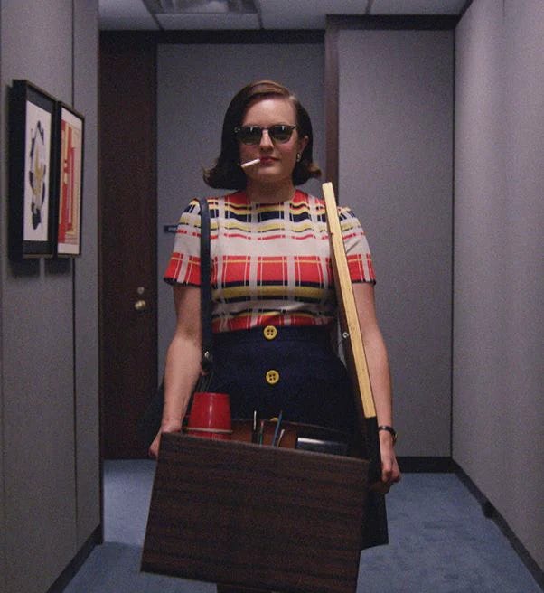 This may contain: a woman is walking down the hallway with her suitcase and coffee cups in her hand