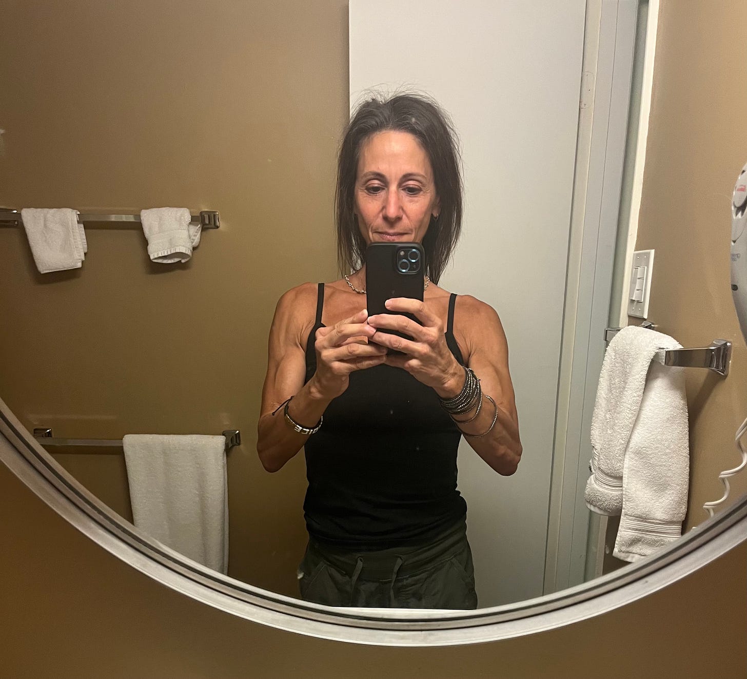 Carla Birnberg taking her annual mirror selfie in her parents’ Pittsburgh guest condo, reflecting on consistency and how small habits build big change.
