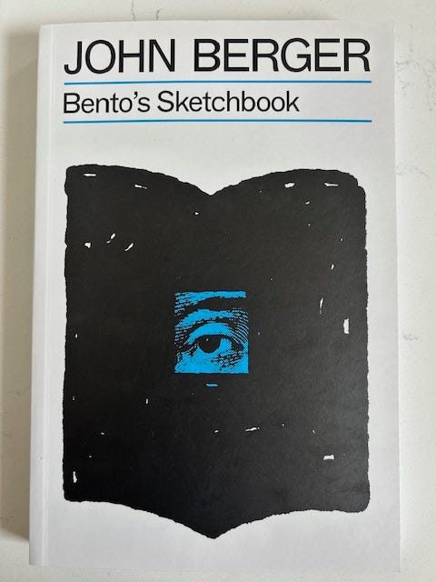 Bento's sketchbook has a white background with a black drawing of a book. A blue eye is in the middle of the black book.